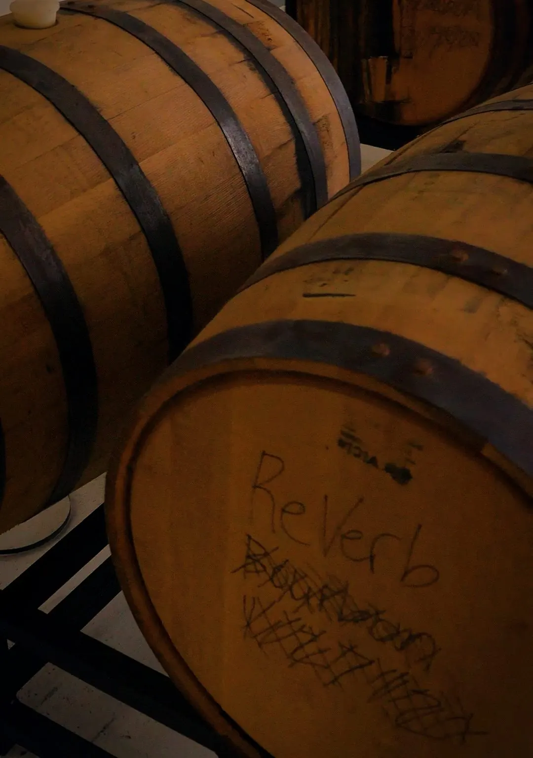 A barrel marked ReVerb Bourbon in chalk
