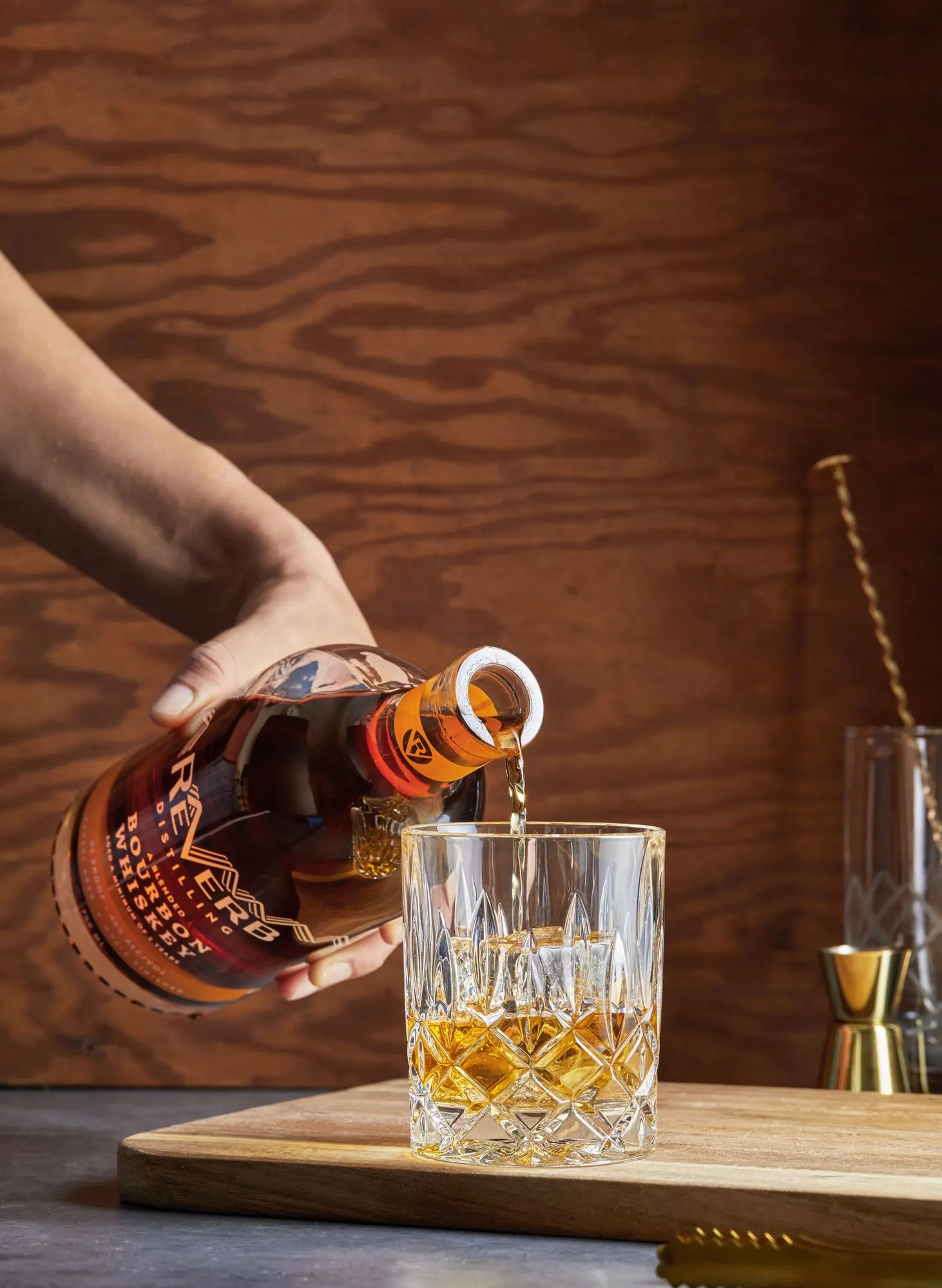 ReVerb Bourbon being poured over a large ice cube