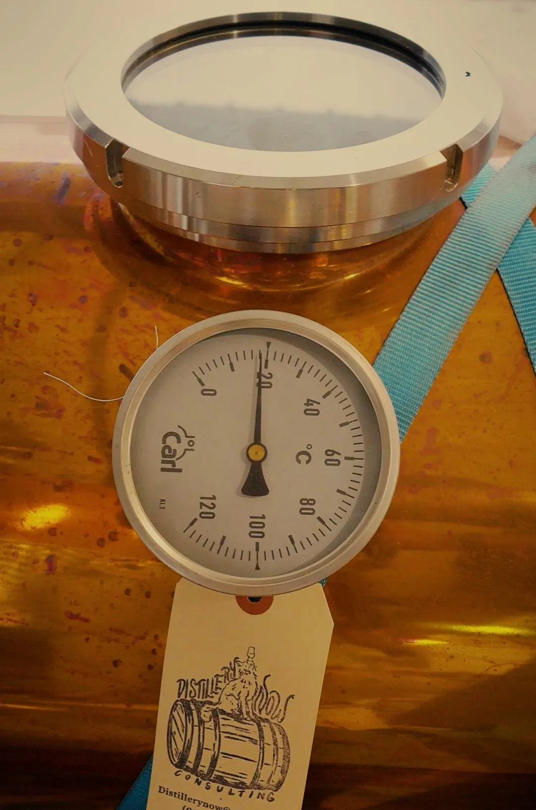 A temperature gauge on a copper still